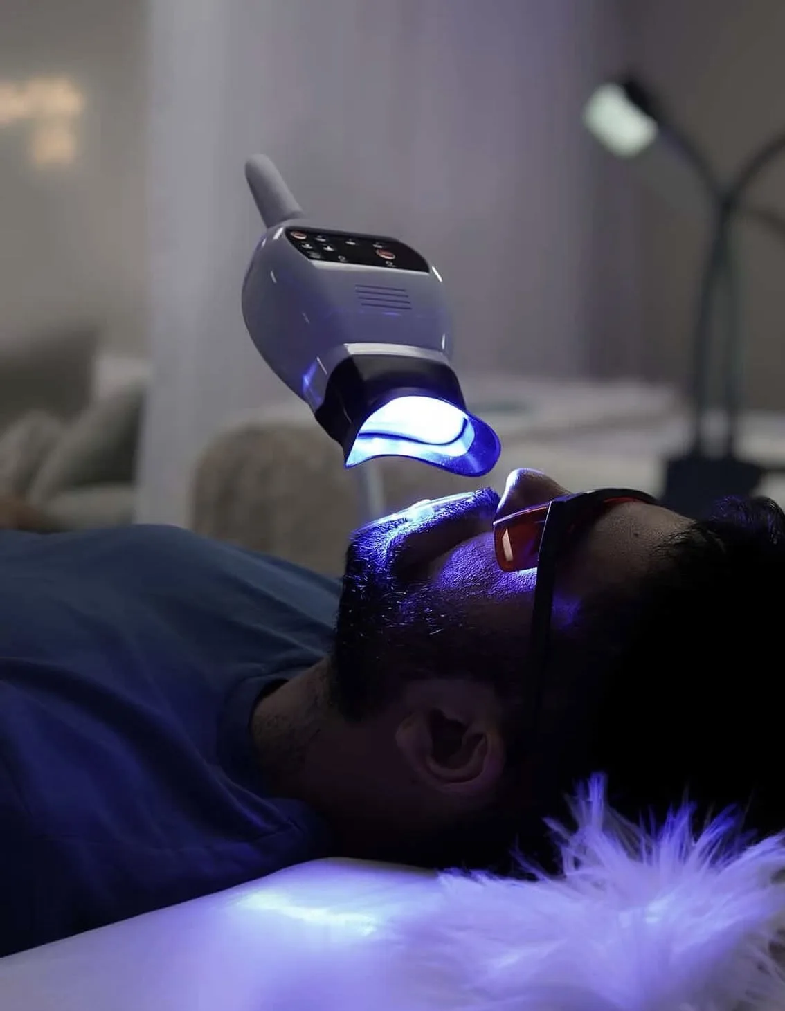 Client under the LED whitening lamp at ProElite Aesthetics